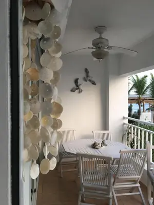 a dining room with a table and shells on the wall at Apartamento Juan Dolio in Juan Dolio