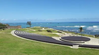 a curvy walkway next to a beach with the ocean at Hotel Kevin in San Felipe de Puerto Plata