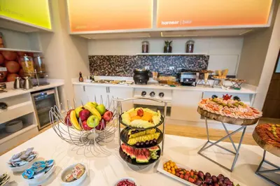 a kitchen with a table with fruit on it at Hampton By Hilton Santo Domingo Airport in Boca Chica