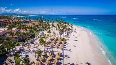 an aerial view of a beach with umbrellas and the ocean at Majestic Colonial Punta Cana - All Inclusive in Punta Cana