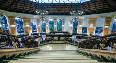 a large building with a staircase and chandeliers at Majestic Elegance Punta Cana - All Inclusive in Punta Cana