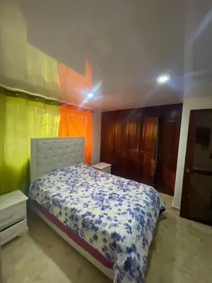 a bedroom with a bed and a colorful wall at Mar azul 401 in San Felipe de Puerto Plata