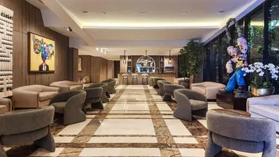 a lobby with chairs and a waiting room at Mauad Hotel Boutique in Santo Domingo