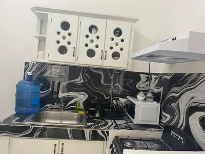 a kitchen counter with a sink and a microwave at Apartamentos Magallanes Romana in La Romana