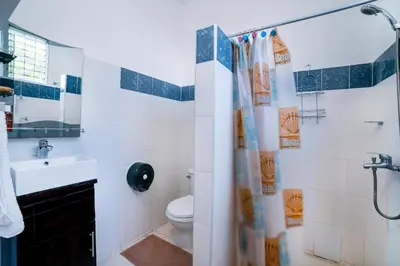 a bathroom with a toilet and a sink and a shower at Apartamentos Magallanes Romana in La Romana
