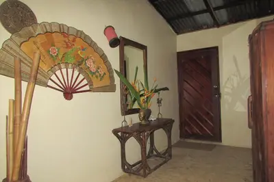 a room with a mirror and a table with a fan at Arroyo Frío River Lodge in Arroyo Frío