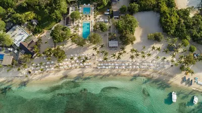 an aerial view of a beach with umbrellas at Casa de Campo Resort & Villas in La Romana