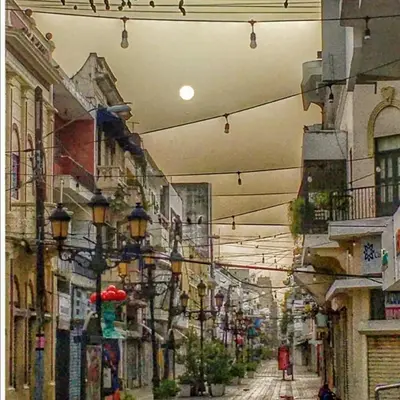 a city street with many buildings and lights at Hotel Class Colonial in Santo Domingo