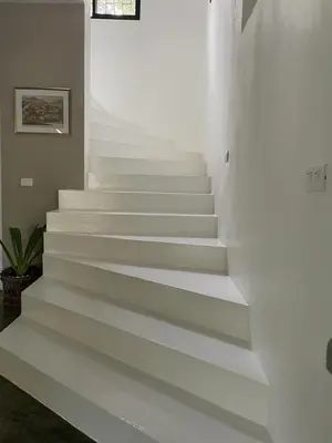 a staircase in a house with white walls and white floors at La Belle Créole in Las Galeras