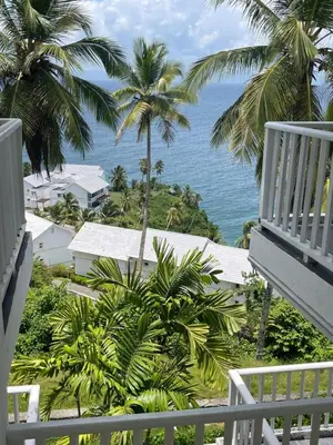 a view of the ocean from the balcony of a resort at Spectacular Ocean View Top Floor 1-Bedroom Condo, Vista Mare, Samana DR in Santa Bárbara de Samaná