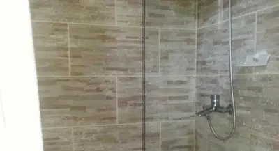 a shower with a glass door in a bathroom at Hotel Luis V Santo Domingo in Santo Domingo