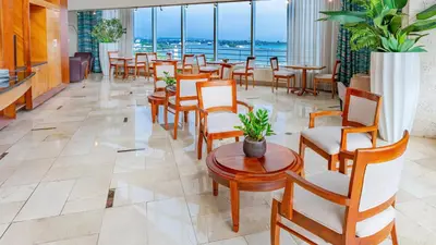 a restaurant with chairs and tables and windows at Crowne Plaza Santo Domingo by IHG in Santo Domingo