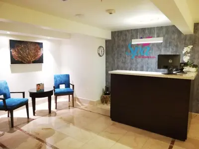 a waiting room at a spa with blue chairs and a table at Crowne Plaza Santo Domingo by IHG in Santo Domingo