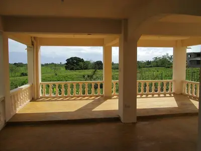 a porch with a view of a green field at Villa Mambo in Patrana