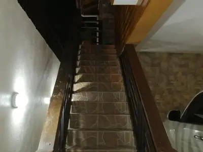 a staircase in a house with a brick wall at Villa Laura Jarabacoa in Jarabacoa