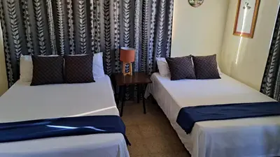 two beds sitting next to each other in a room at Casa D9 in Santo Domingo