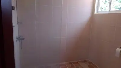 a bathroom with a shower with a glass door at Casa D9 in Santo Domingo