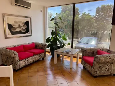 a living room with couches and a table and a car at Aparta Hotel Plaza del Sol in Santo Domingo
