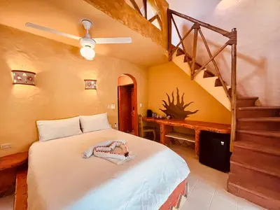 a bedroom with a bed and a staircase at Hotel La Tortuga in Las Terrenas