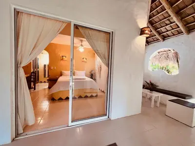 a bedroom with a bed and a large window at Hotel La Tortuga in Las Terrenas