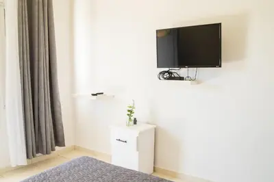 a room with a flat screen tv on a wall at Hotel Casa Pierretta in Las Terrenas