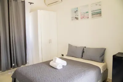 a bedroom with a bed with a white towel on it at Hotel Casa Pierretta in Las Terrenas