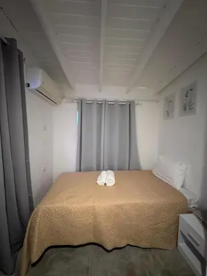 a bed with two towels on it in a room at Hotel Casa Pierretta in Las Terrenas