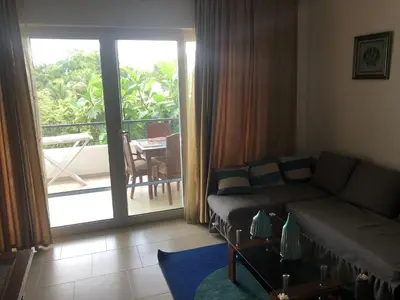 a living room with a couch and a view of a balcony at Vacations in the Caribbean Paradise in Sosúa