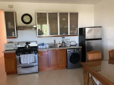 a kitchen with a stove and a sink and a refrigerator at Vacations in the Caribbean Paradise in Sosúa