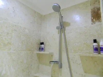 a shower with a shower head in a bathroom at Figaro Hotel Samana in Santa Bárbara de Samaná