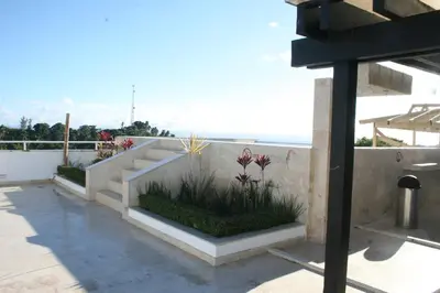 a concrete staircase with flowers on the side of a building at Figaro Hotel Samana in Santa Bárbara de Samaná