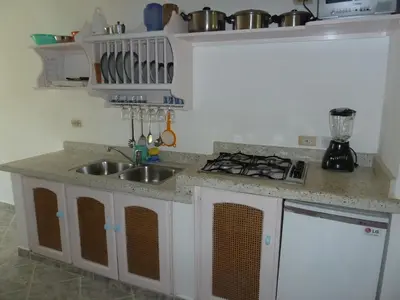 a kitchen with a sink and a stove at Hotel Playa Colibri in Las Terrenas