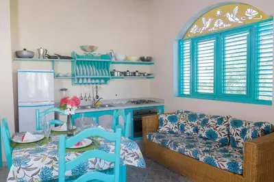 a living room with a couch and a table at Hotel Playa Colibri in Las Terrenas