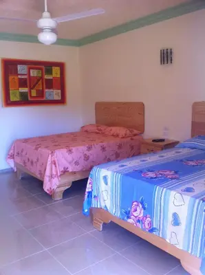a room with two beds in a room at Hotel Cambri in Nagua