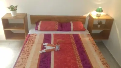a bedroom with a bed with two dolls on it at Casa Picadilly in Boca Chica