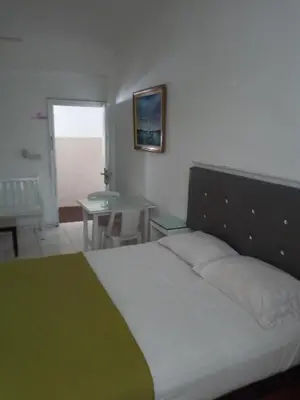 a bedroom with a bed and a table and a table at Royal Palace Hotel in Santo Domingo