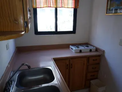 a small kitchen with a sink and a window at Royal Palace Hotel in Santo Domingo
