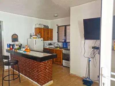 a kitchen with a brick counter and a refrigerator at Perla de Sosua in Sosúa