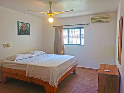 a bedroom with a bed and a ceiling fan at Perla de Sosua in Sosúa