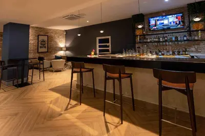 a bar with bar stools in a room at Coral Costa Caribe Beach Resort - All Inclusive in Juan Dolio