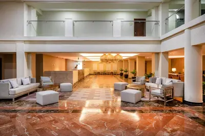 a large lobby with couches and tables in a building at Coral Costa Caribe Beach Resort - All Inclusive in Juan Dolio