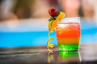 a drink with a flower on top of a table at Wyndham Alltra Samana All Inclusive Resort in Las Galeras