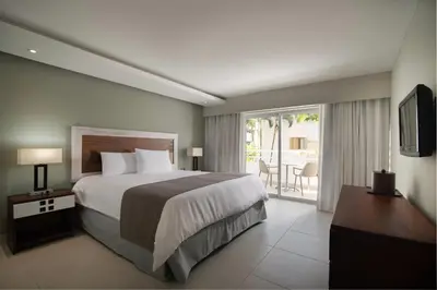 a hotel room with a bed and a balcony at Casa Marina Sosua, Trademark by Wyndham All Inclusive in Sosúa