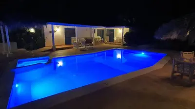 a swimming pool at night with blue lights at Casa Giò in Las Terrenas