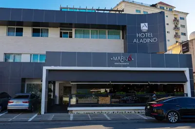 a hotel avalon building with a car parked in front at Hotel Aladino in Santo Domingo