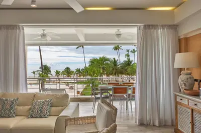 a living room with a couch and a view of the ocean at Juan Dolio Costa del Sol in Juan Dolio
