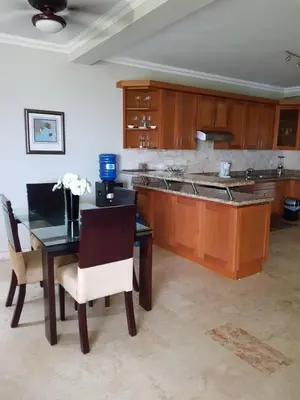 a kitchen with a table and chairs and a counter at Luxury Oceanview Condo 2 BR/2.5 BA in Sosúa