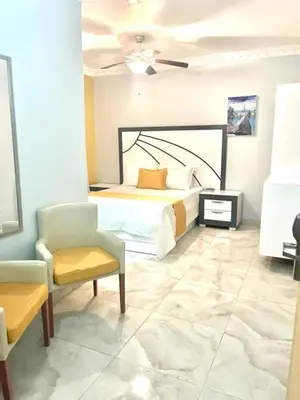 a bedroom with a bed and a chair at Hotel Sand Bay in Punta Rucia