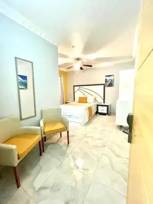 a hotel room with a bed and a chair at Hotel Sand Bay in Punta Rucia