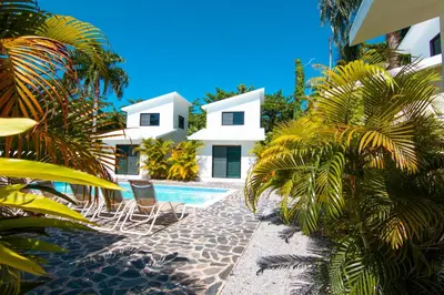 a house with two chairs and a swimming pool at Residence Las Dos Palmas in Las Terrenas